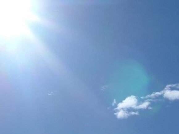 Ciel bleu avec le soleil au coin à gauche