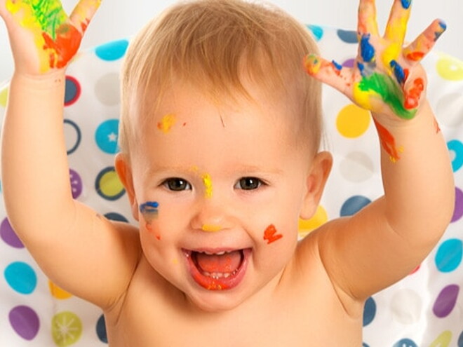 bébé content, les mains avec de la peinture colorée bébé content, les mains avec de la peinture colorée