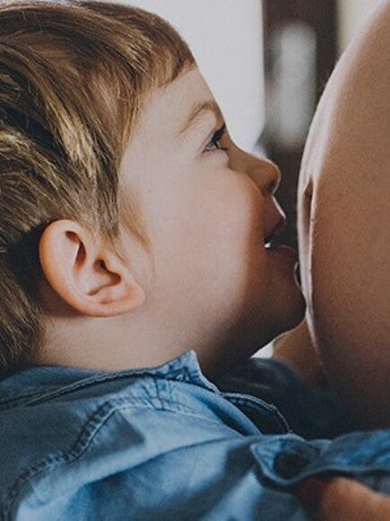 Toddler kisses mommy's baby